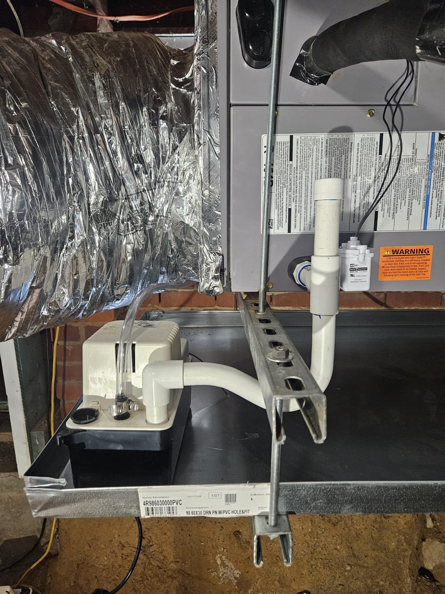 New HVAC system component with a condensate pump and piping, installed with expert care