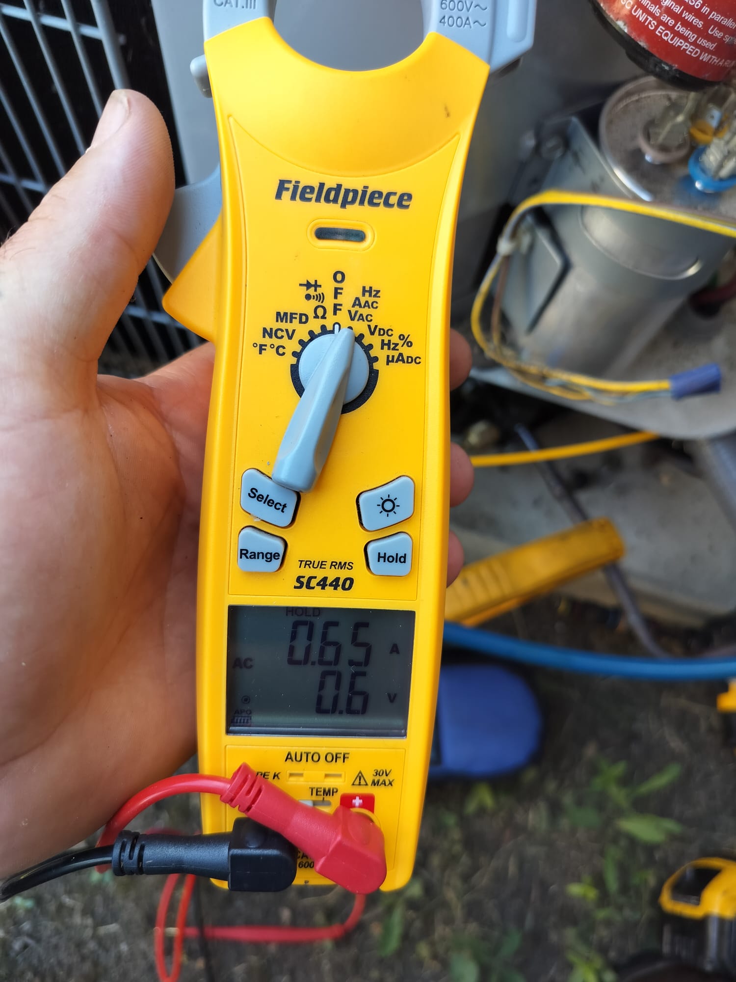 HEP technician using digital measuring tools during service