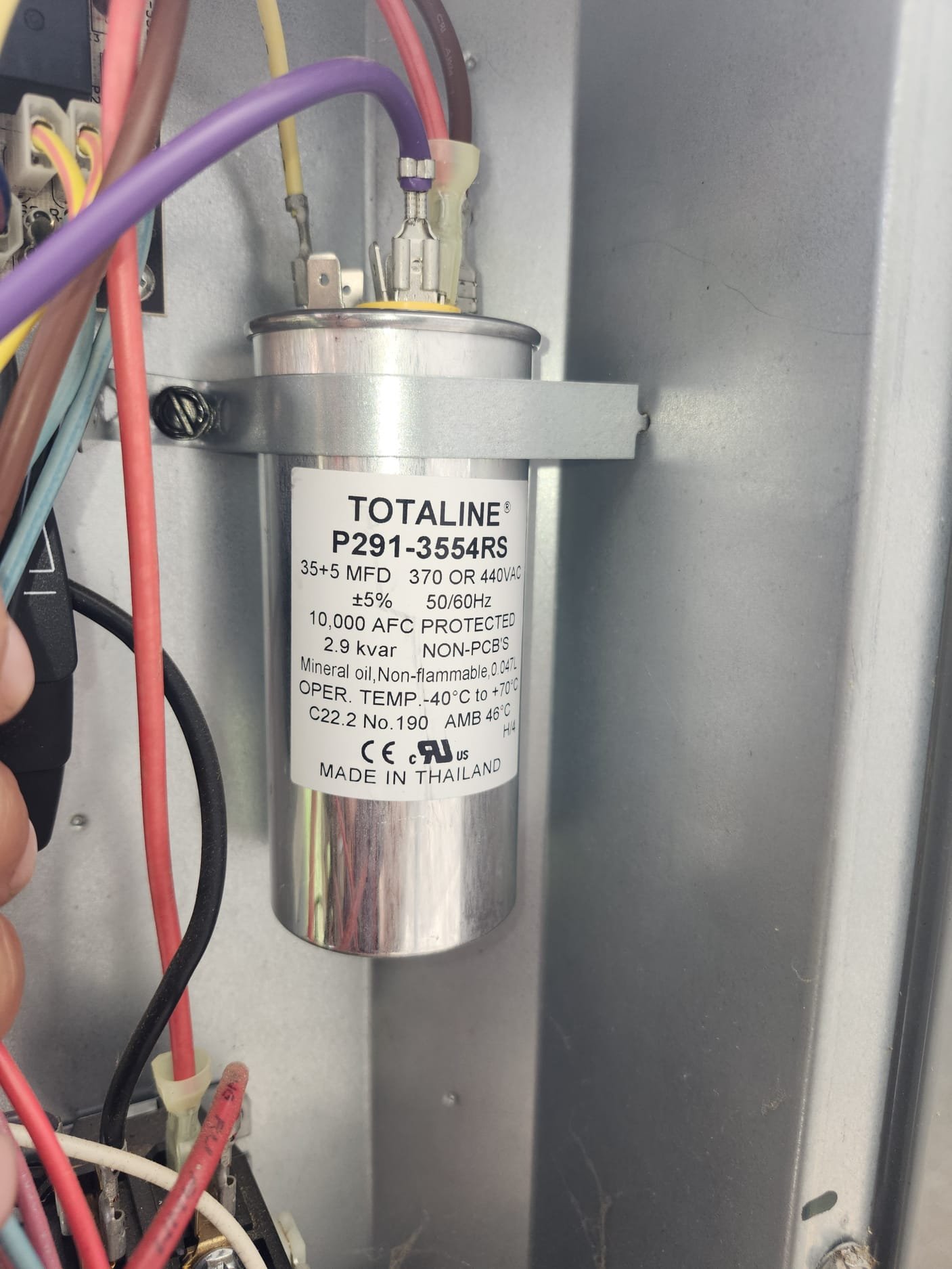 Newly installed electrical component inside an HVAC unit demonstrating proper setup after repair work