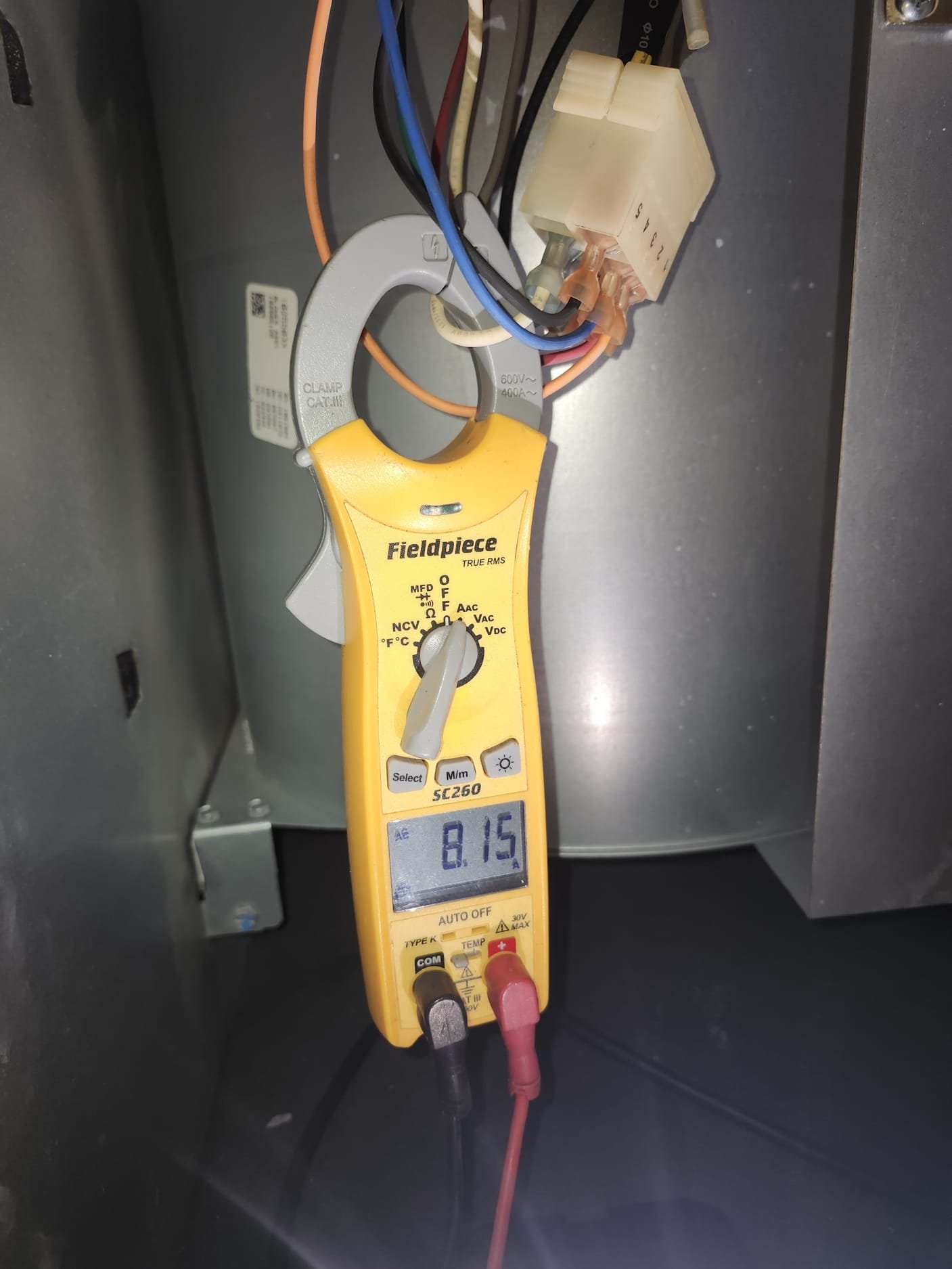 Fieldpiece SC260 clamp meter in use inside an HVAC unit