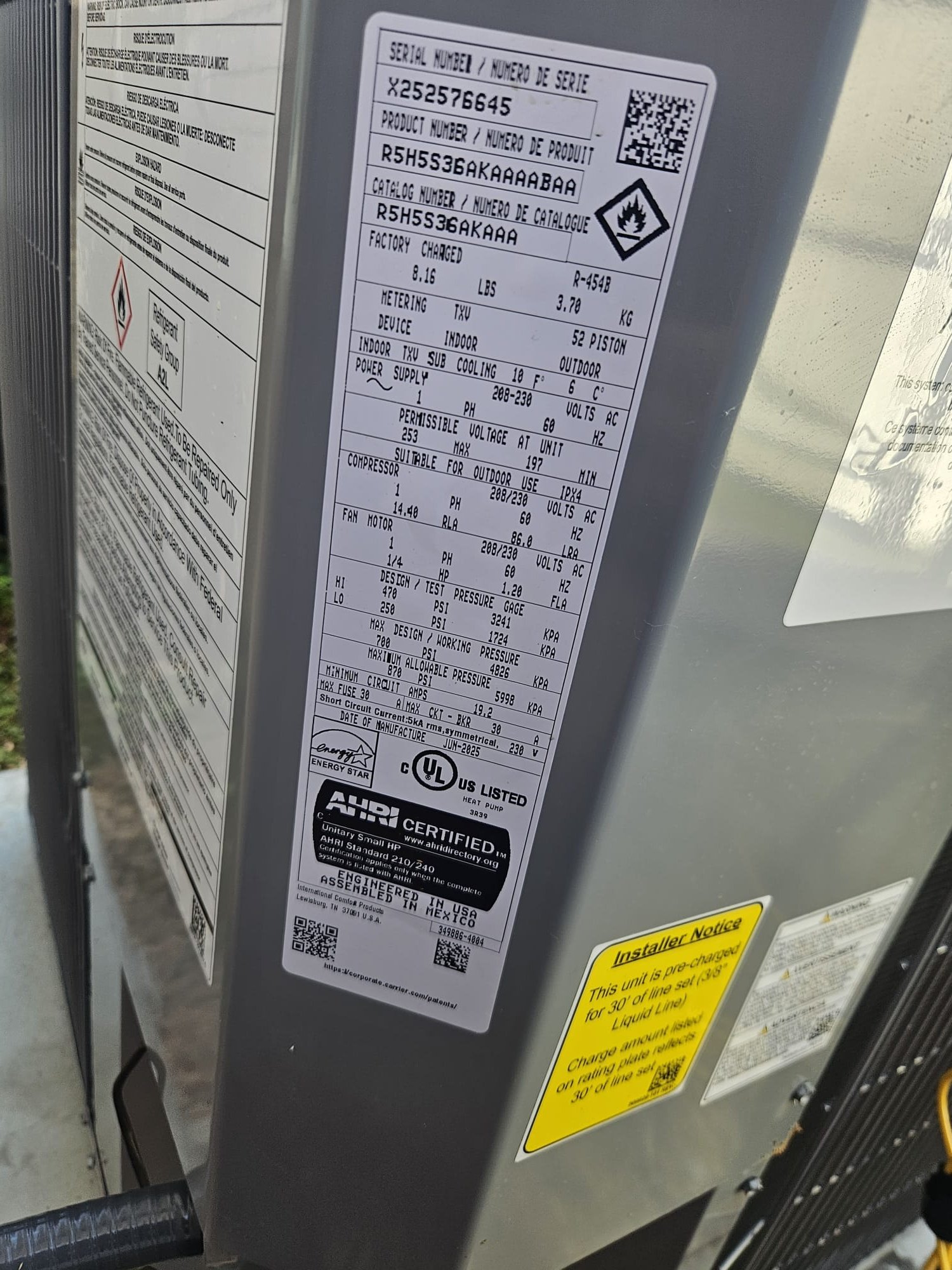 Side panel of a freshly installed outdoor unit with intact labeling.
