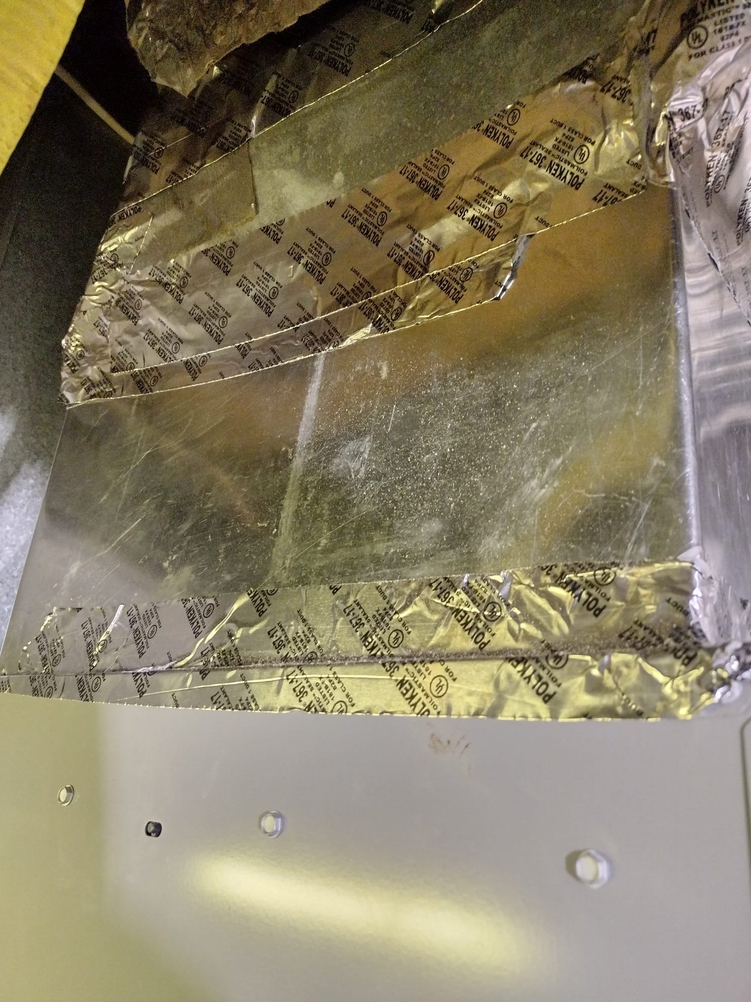 Sealed ductwork with metallic foil tape to prevent air leaks.