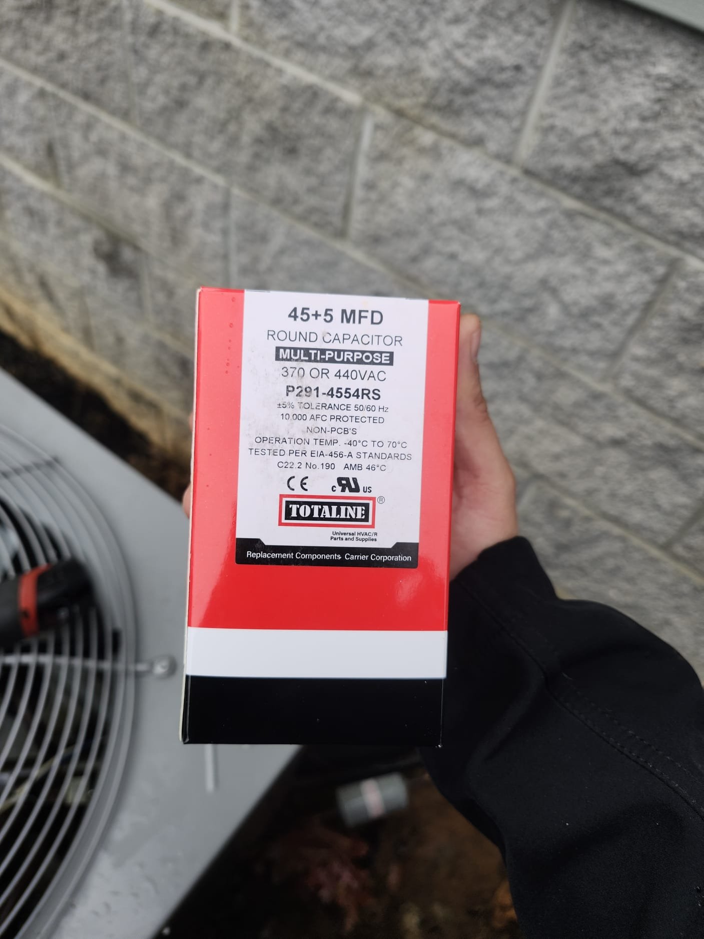 A new replacement capacitor box ready for installation on an HVAC system, ensuring reliable starts and smooth operation.