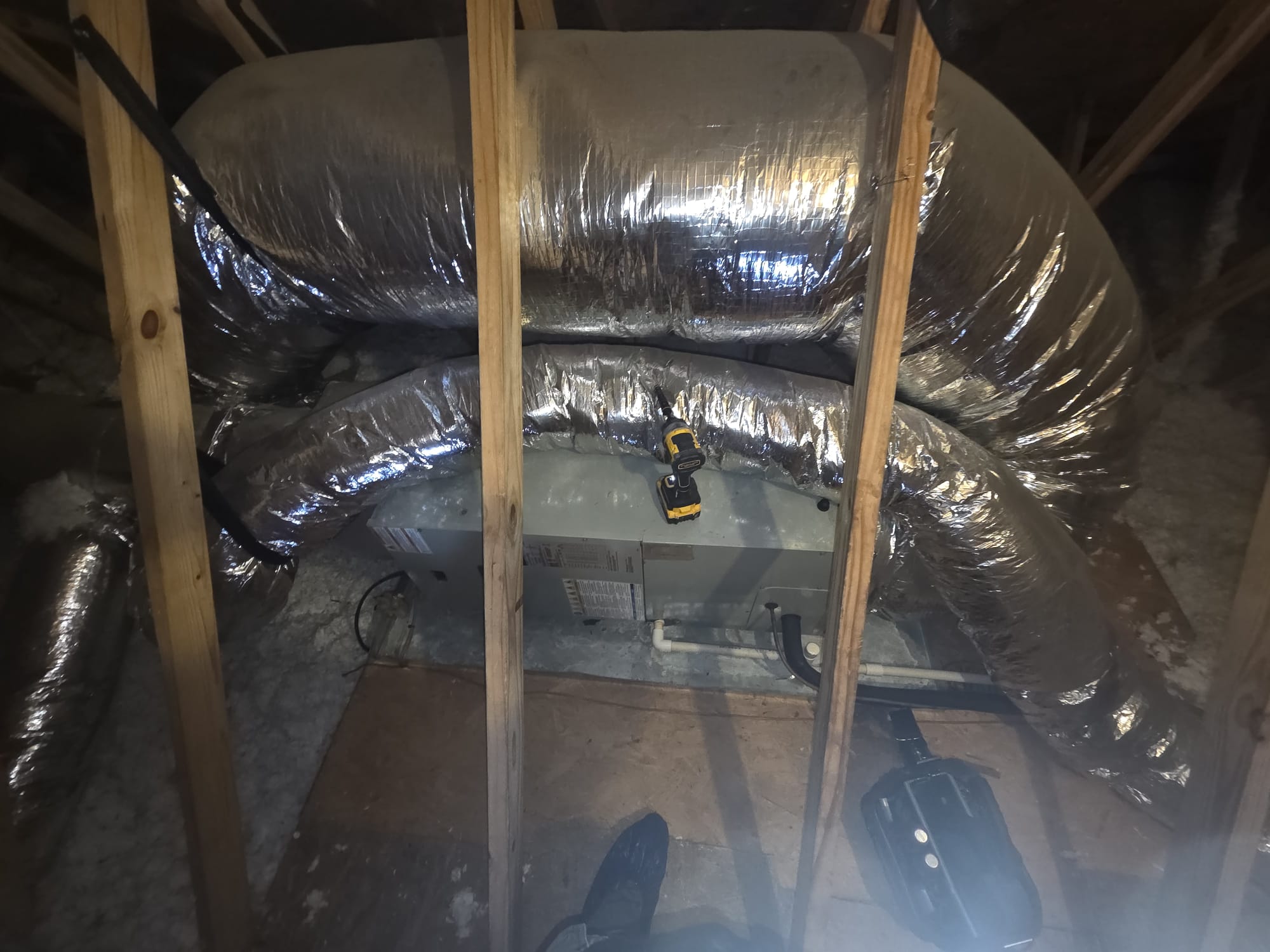 HVAC Air Handler in Attic with Insulated Ducts and Tools
