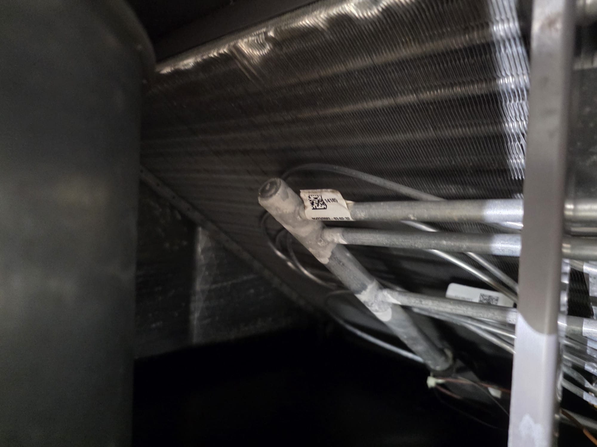 New refrigerant lines and clean evaporator coil inside an HVAC system
