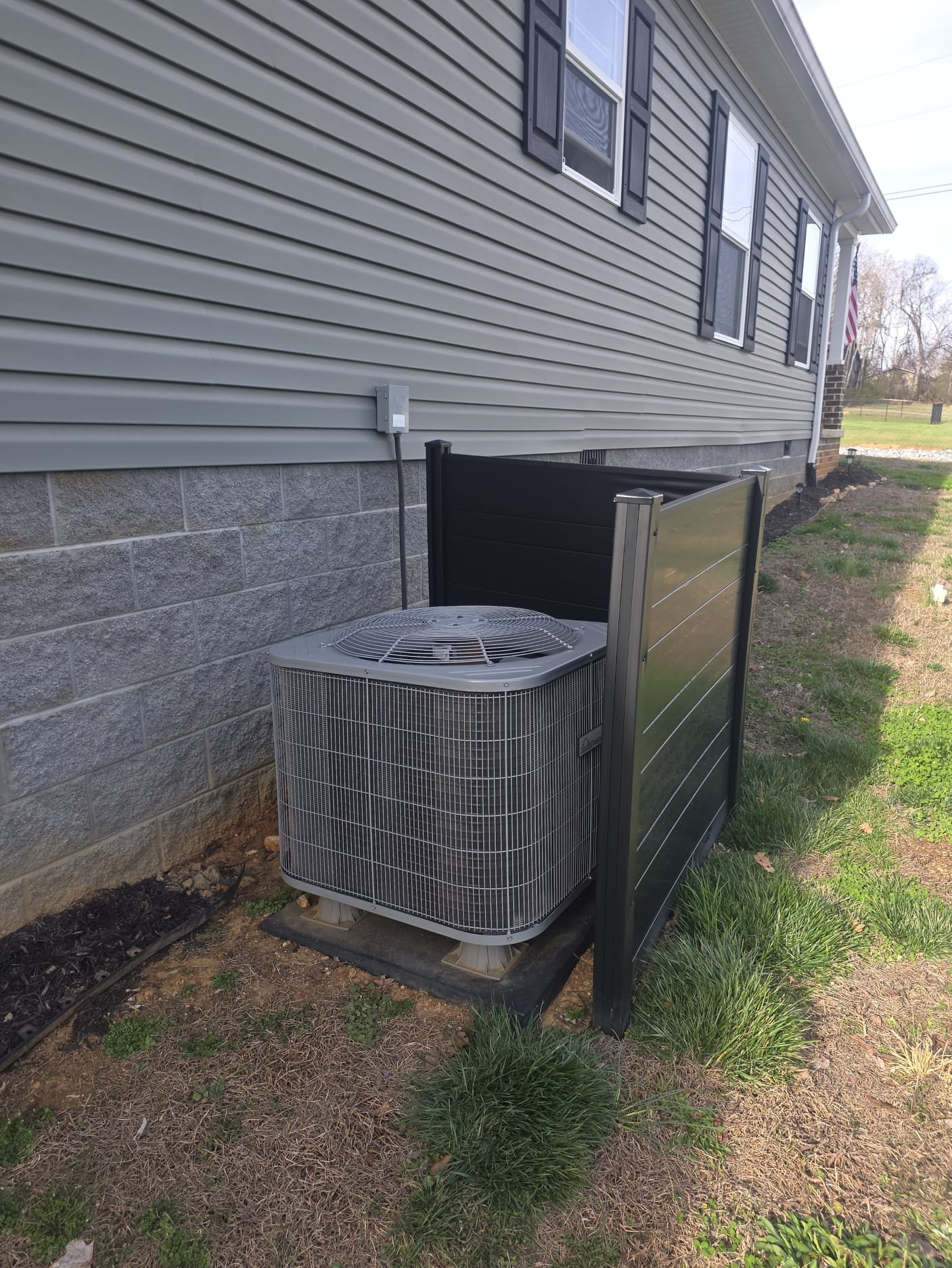 Protective barrier around an outdoor unit