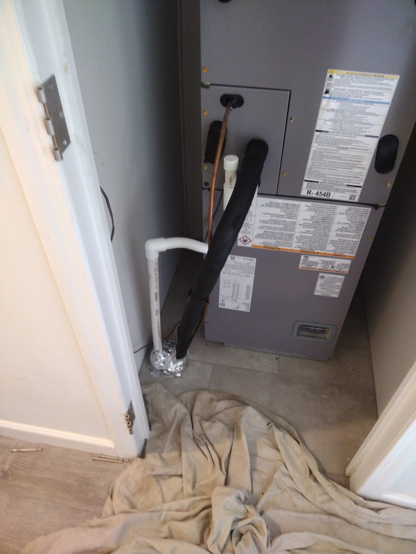 Indoor HVAC air handler in a utility closet