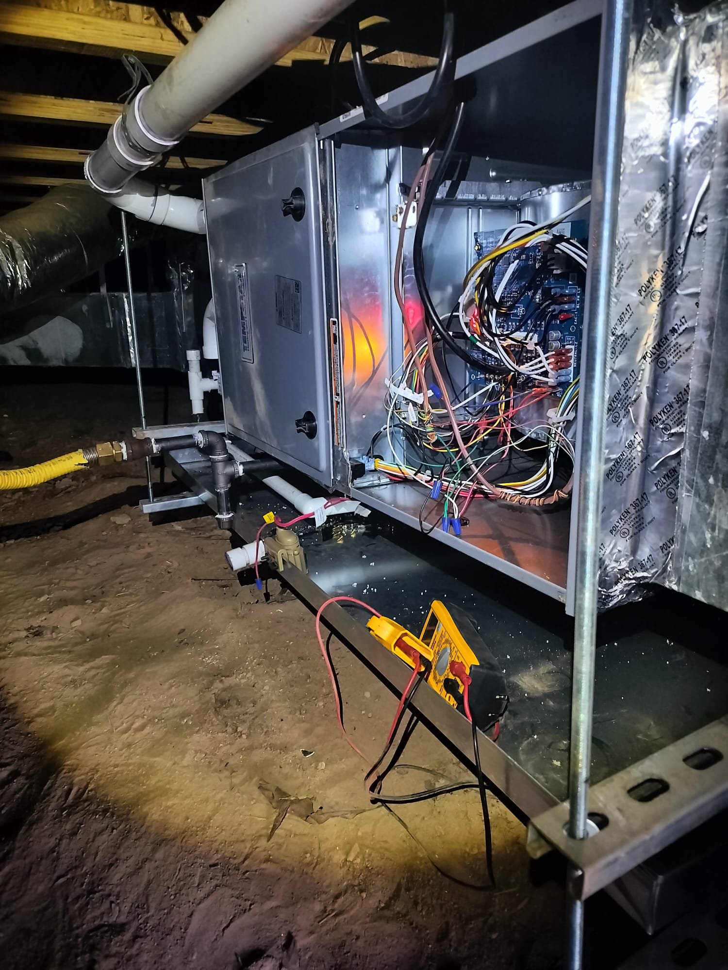 Open service panel in crawl space during maintenance