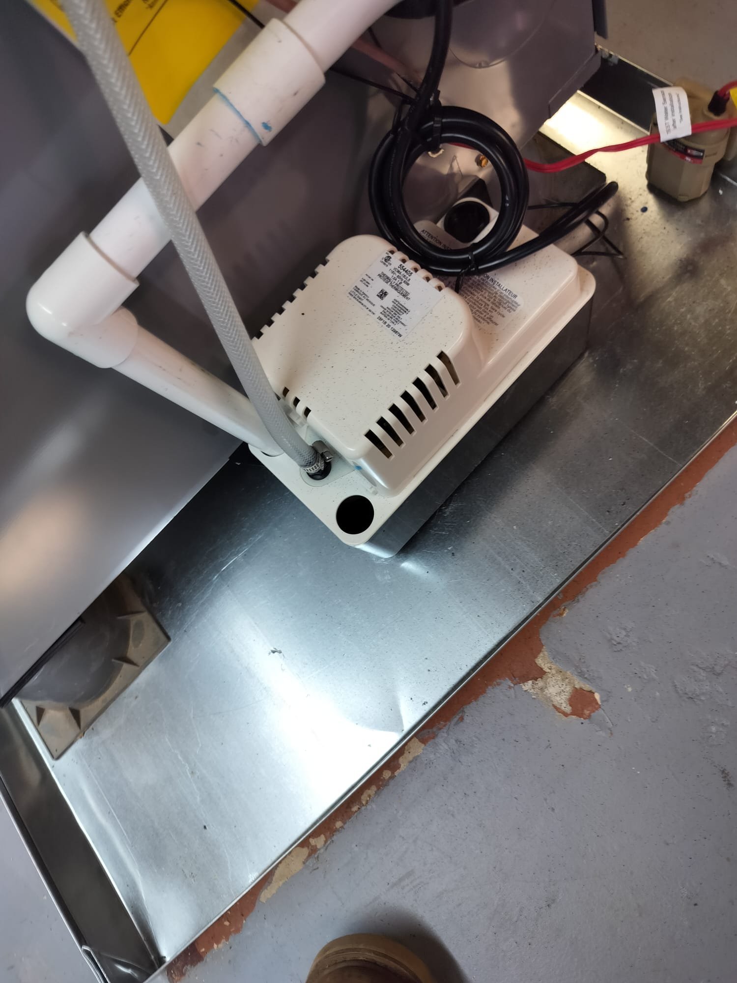 New condensate pump and drain piping installed