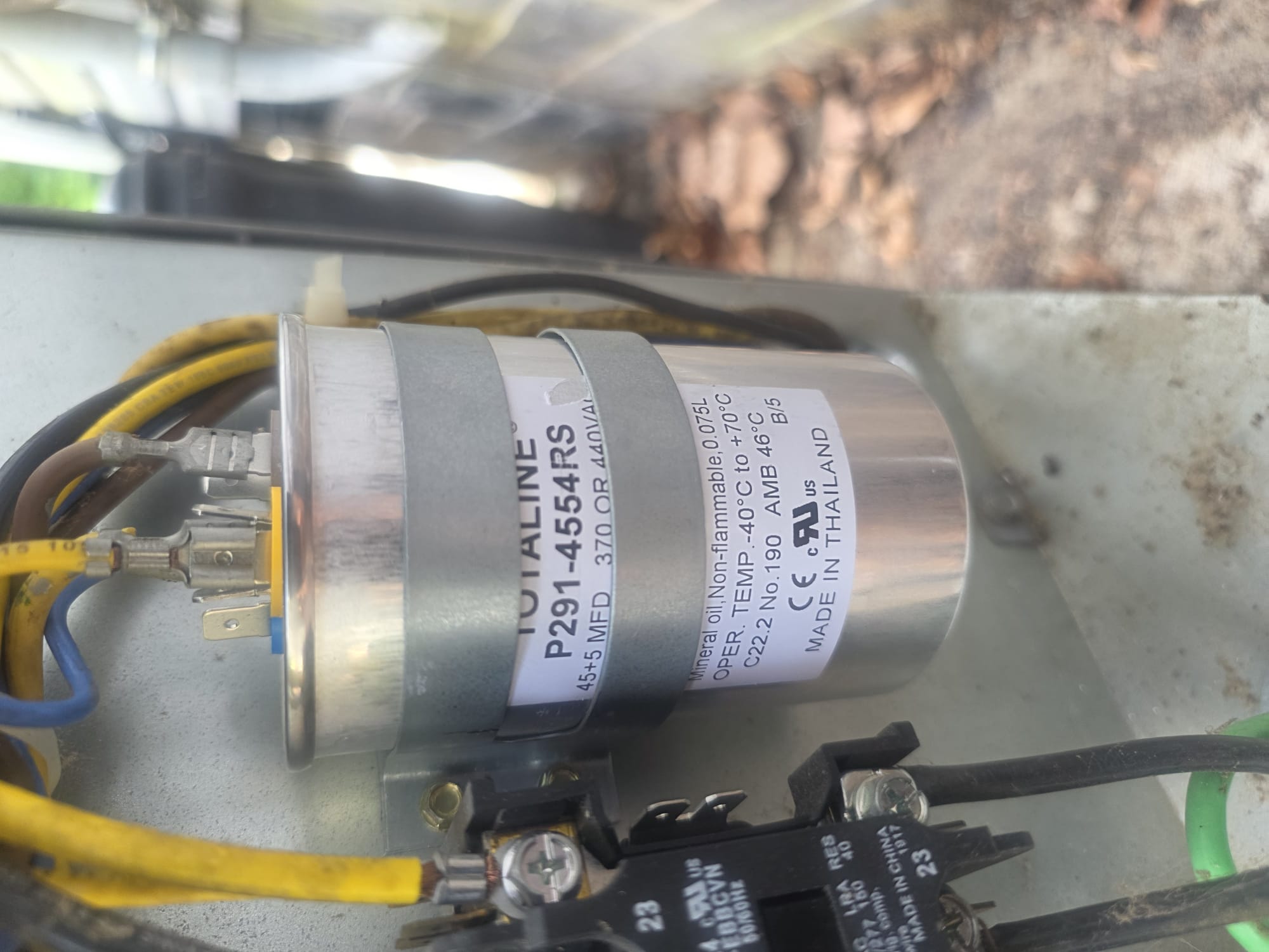 A freshly replaced HVAC capacitor inside an outdoor unit