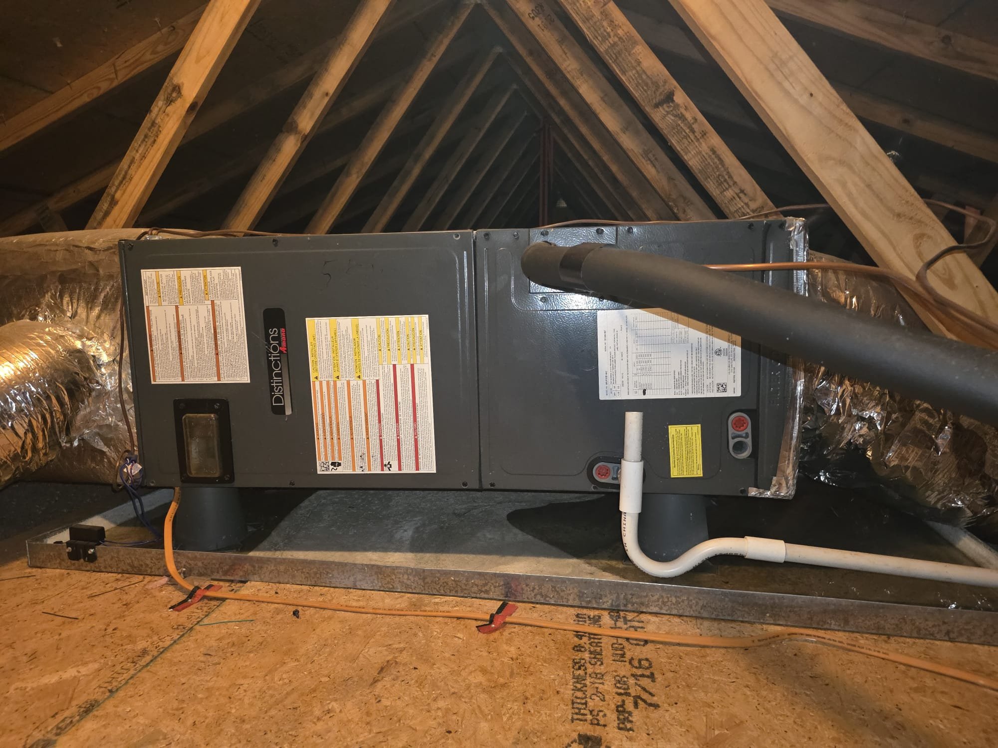 An attic HVAC air handler and drain setup