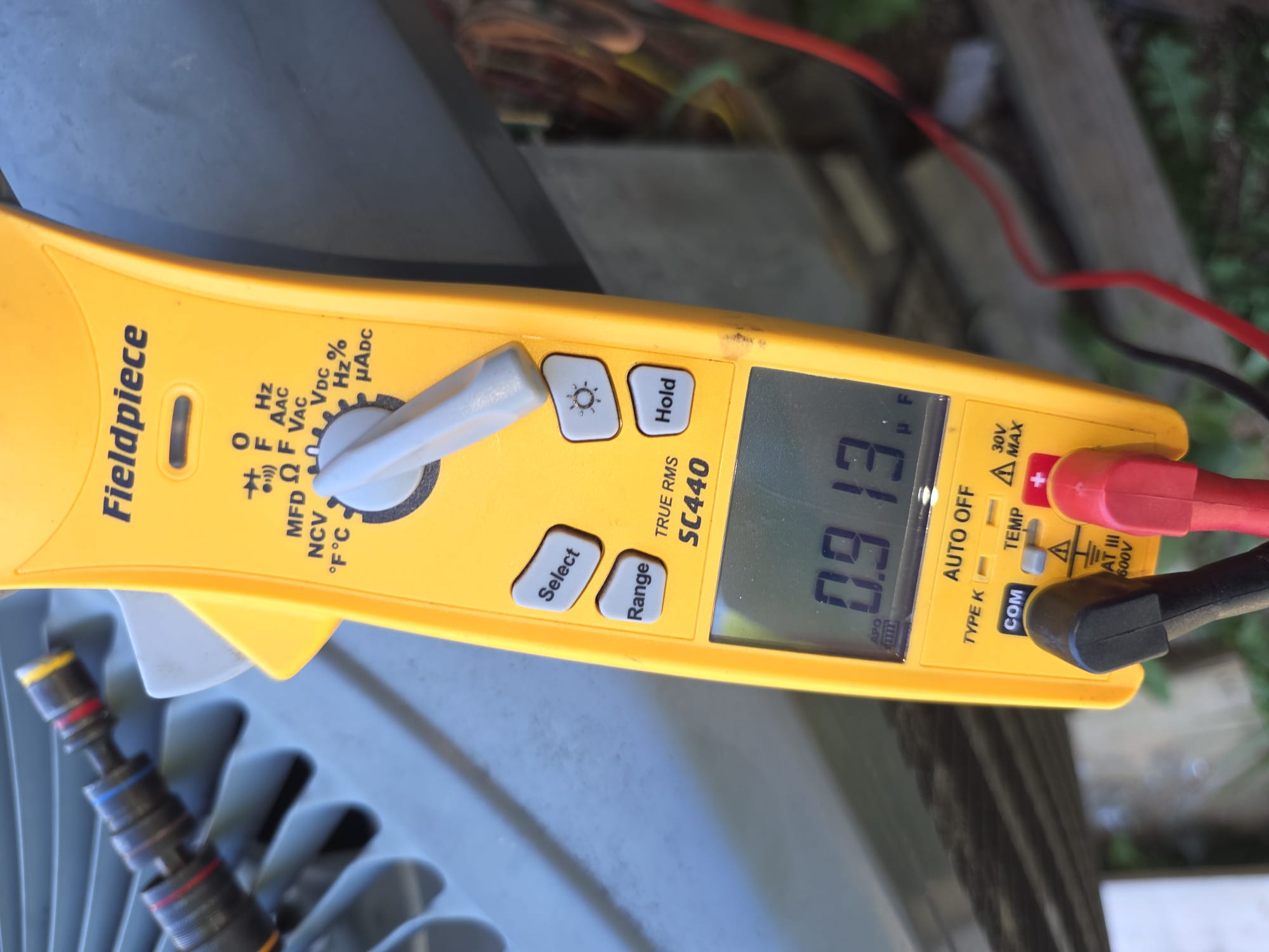 HEP technician checking electrical readings during diagnosis