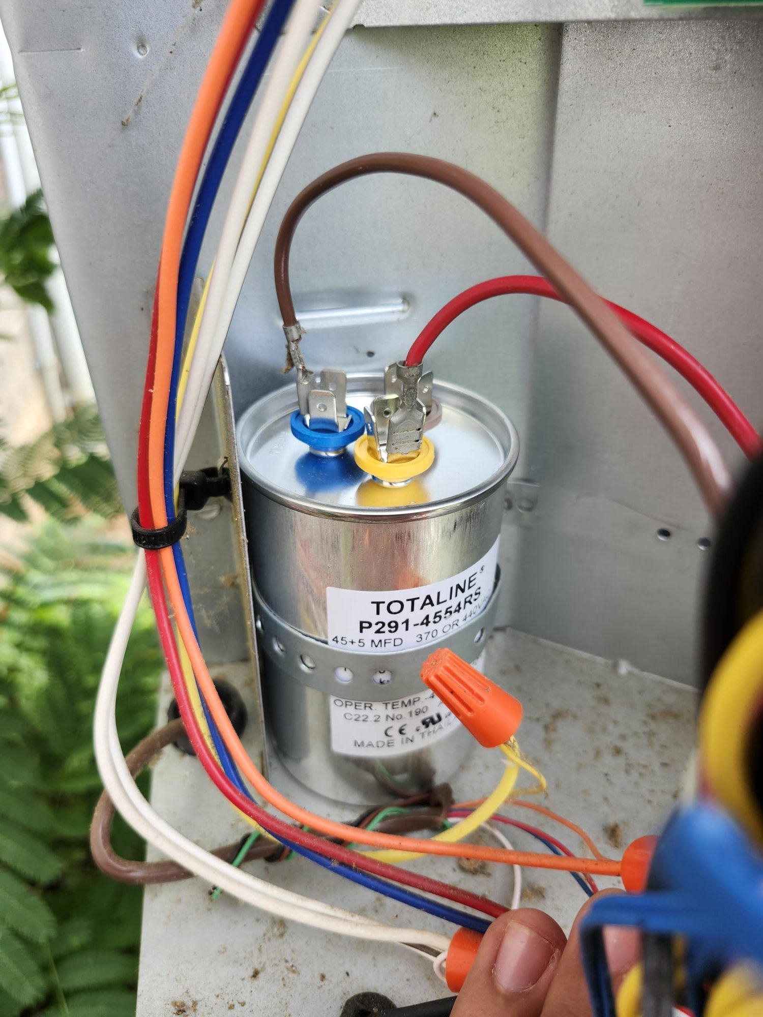 A fresh replacement part inside the outdoor unit
