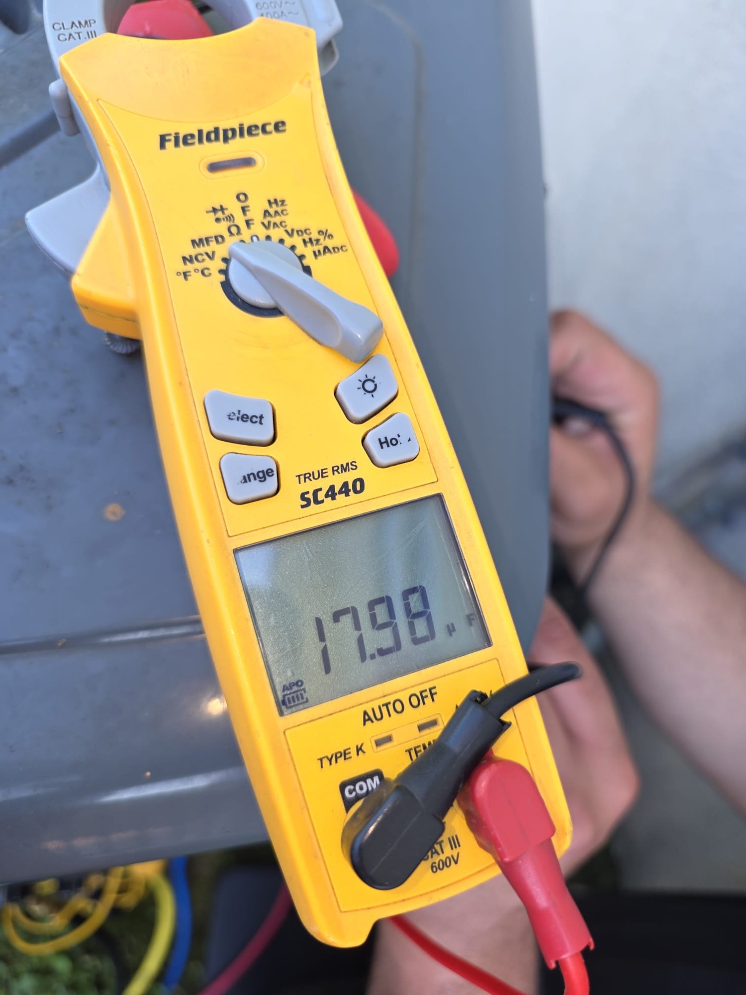 HEP technician testing an HVAC electrical component