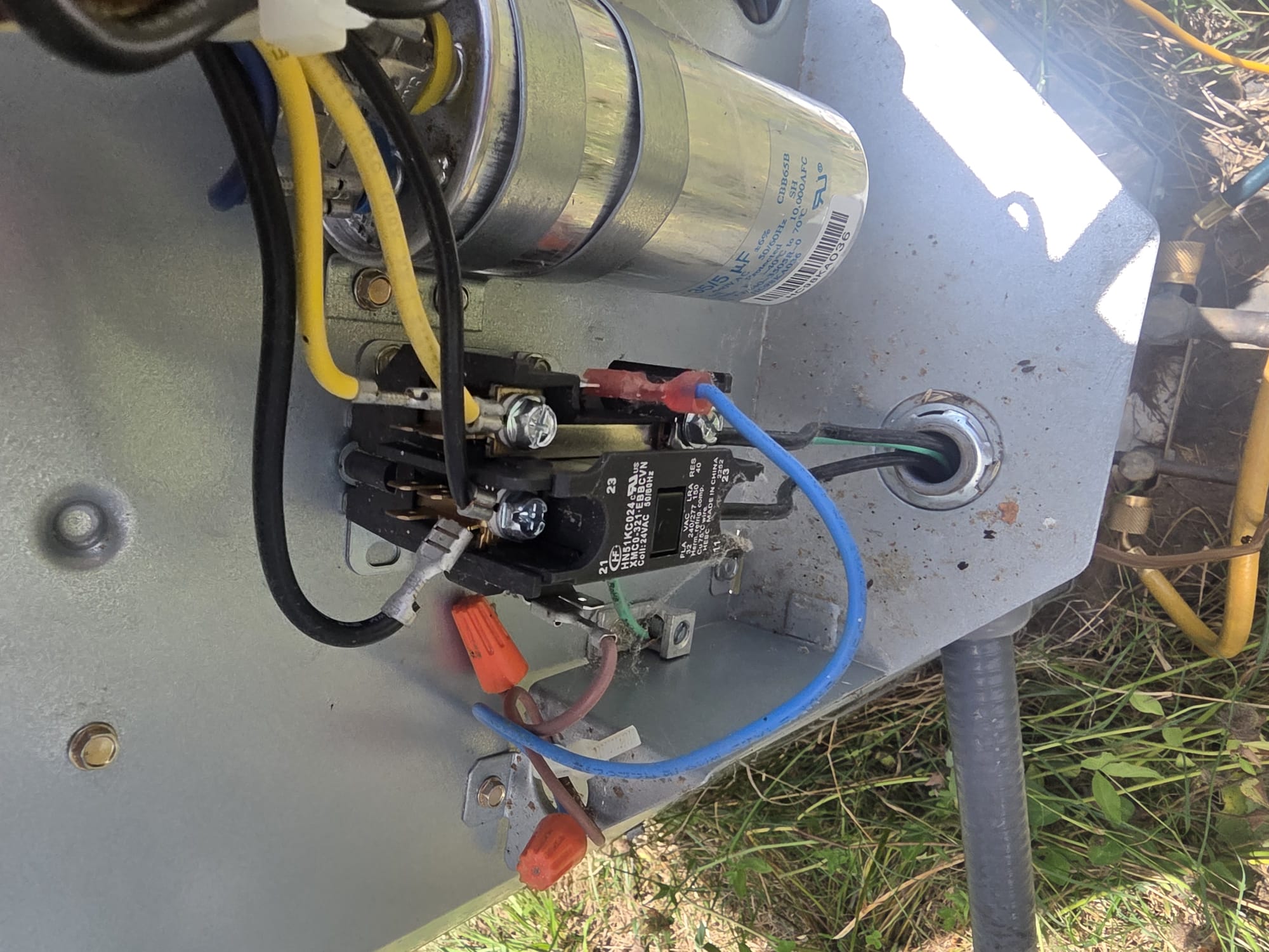 Open electrical compartment inside an outdoor AC unit