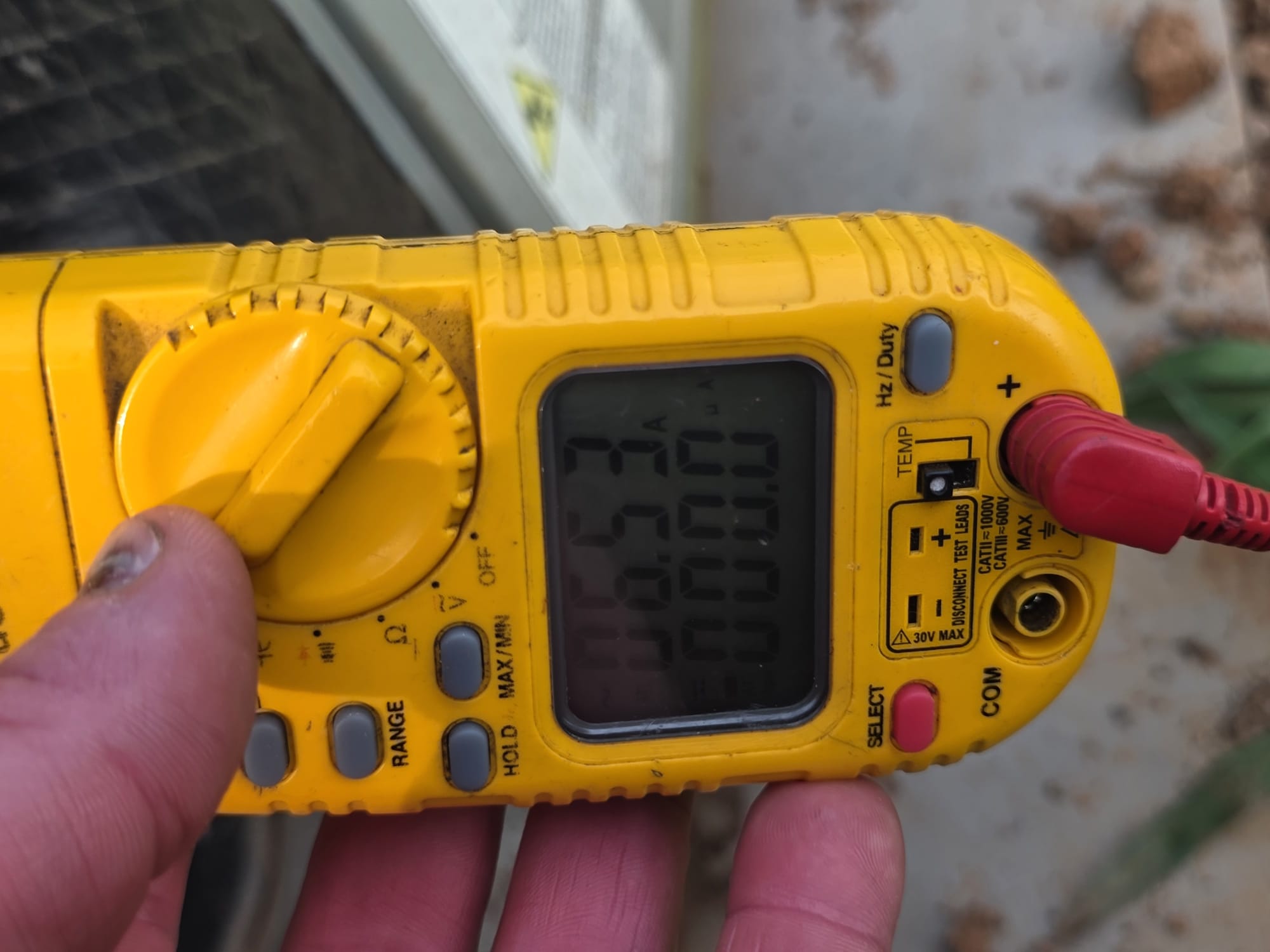 Technician checking electrical readings on HVAC equipment