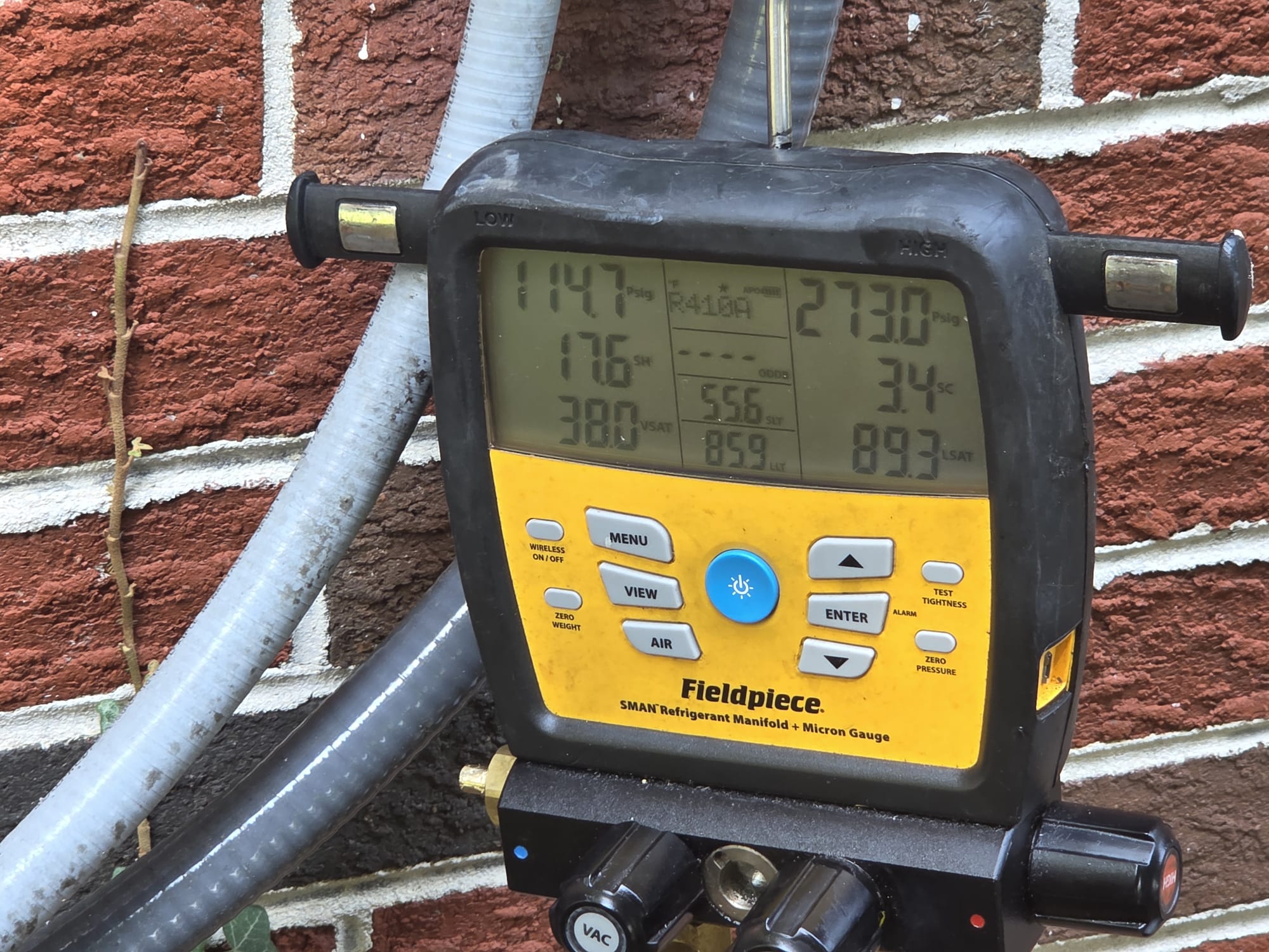 Technician checking refrigerant readings