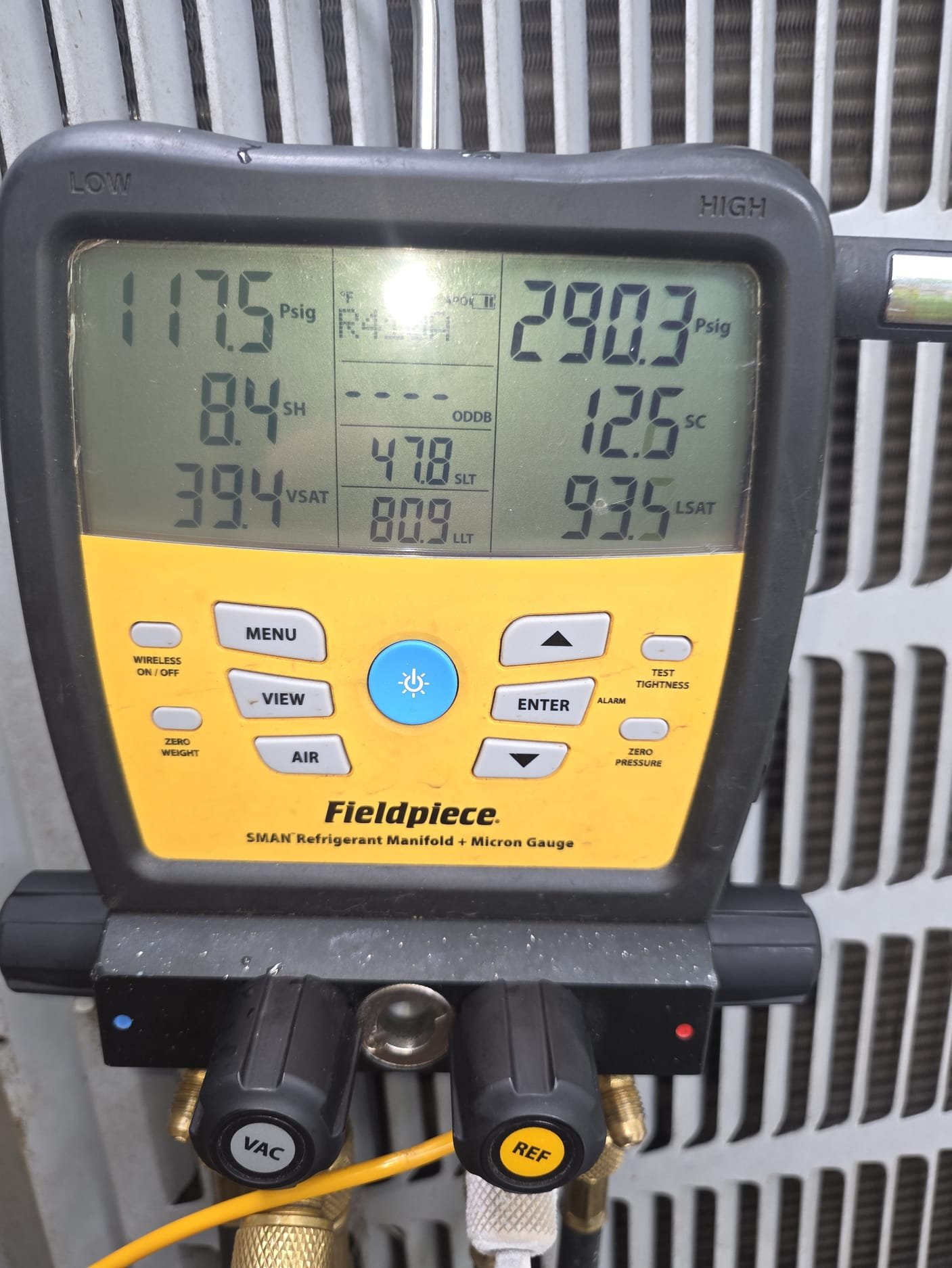 HEP technician checking refrigerant readings during a service call