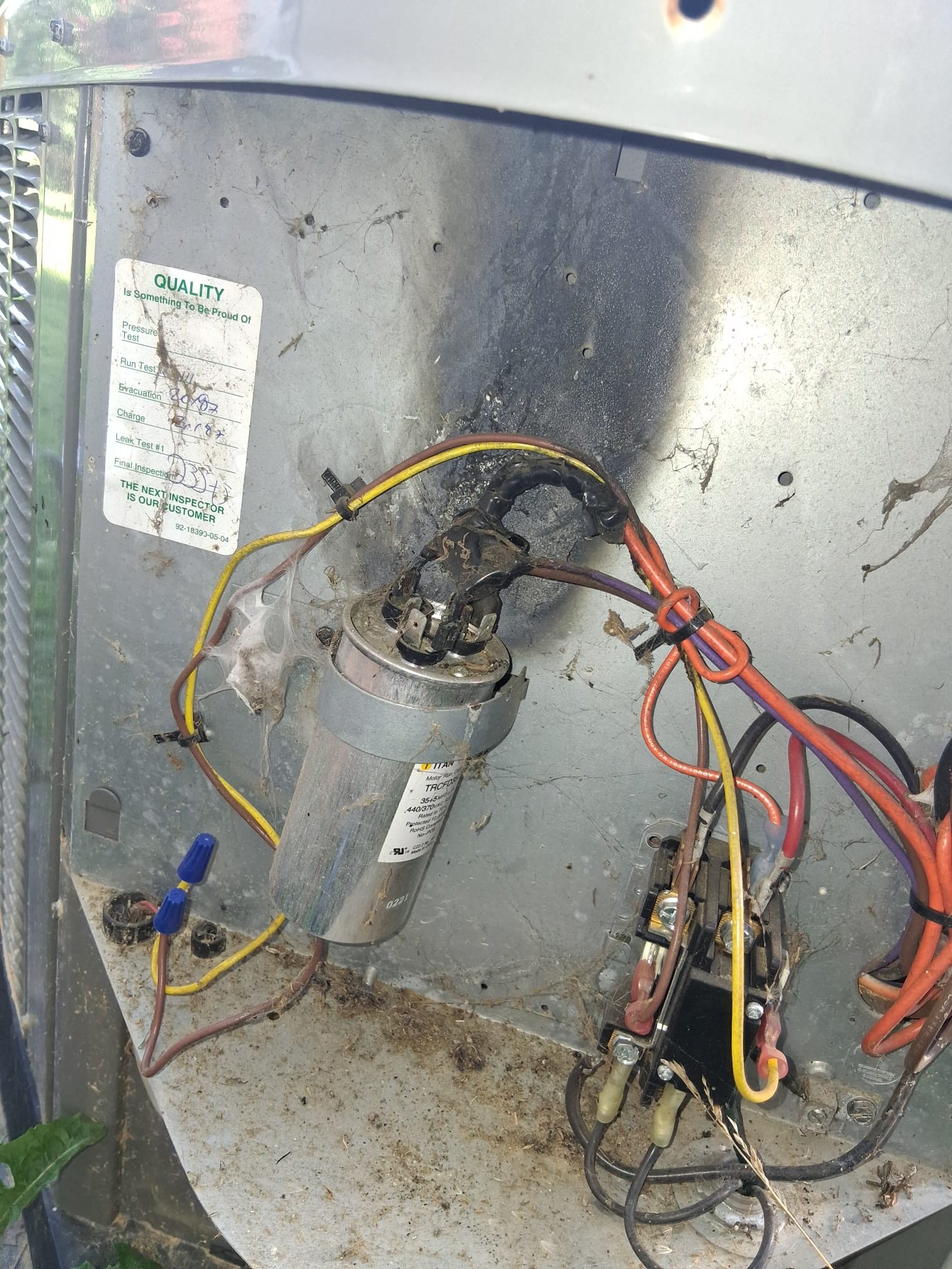 Heat-damaged wiring inside an outdoor HVAC unit