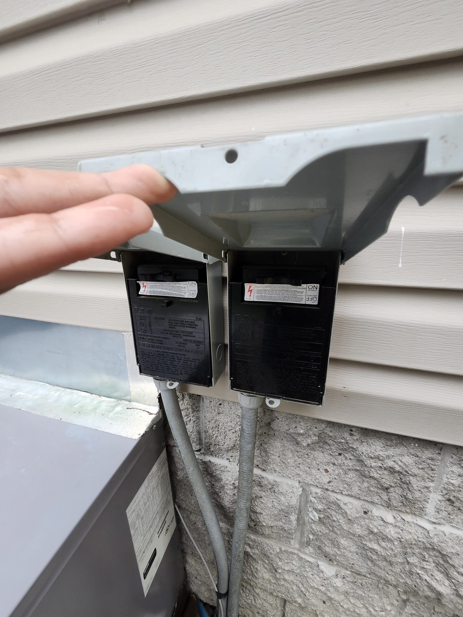 Outdoor HVAC electrical disconnect boxes with a damaged cover